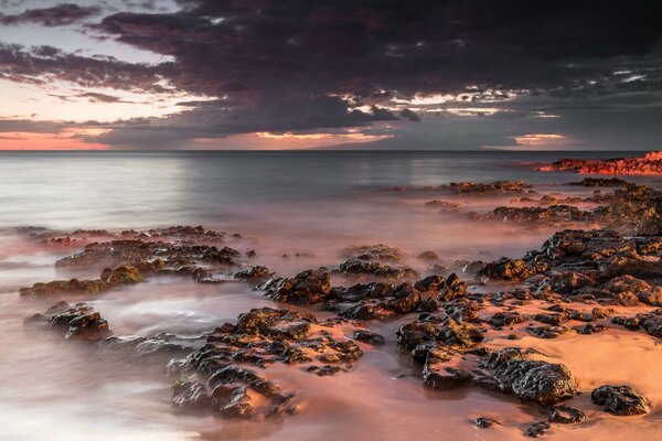 Dark clouds over a Hawaiian beach