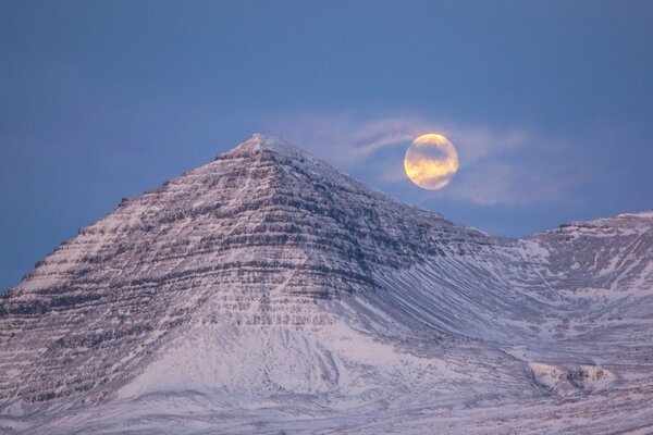 Full moon in the mountains with a haze in Iceland