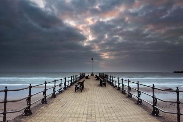 Bridge by the sea in cloudy weather