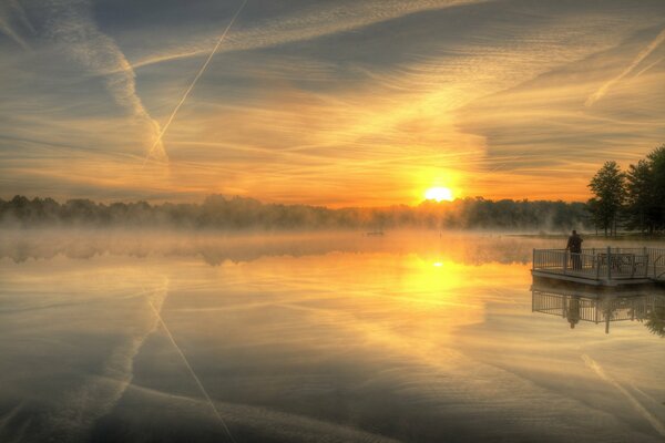 Landscape with lake and sunset on fog background