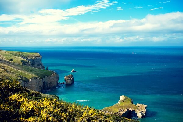 Rocky seashore with emerald blue water