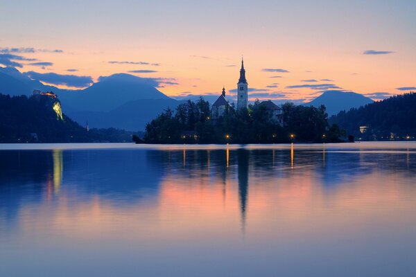 A sharp spire over a quiet lake