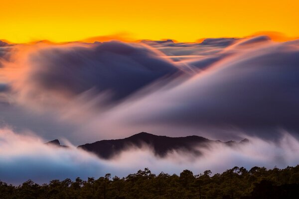 Mountain dawn in the cloud fog