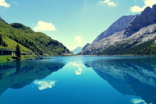 Reflection of a mountain slope in a blue lake