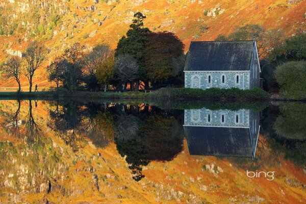 Landscape with a house on the lake shore