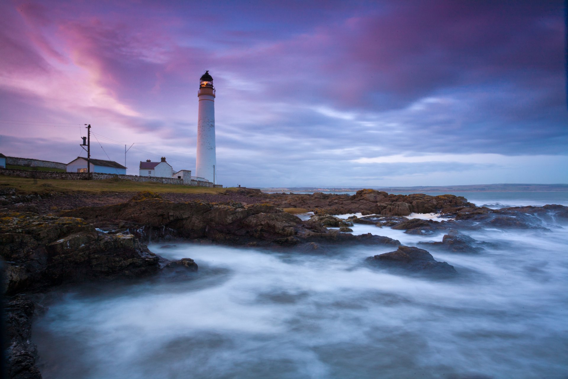 lighthouse ocean rock stones wave