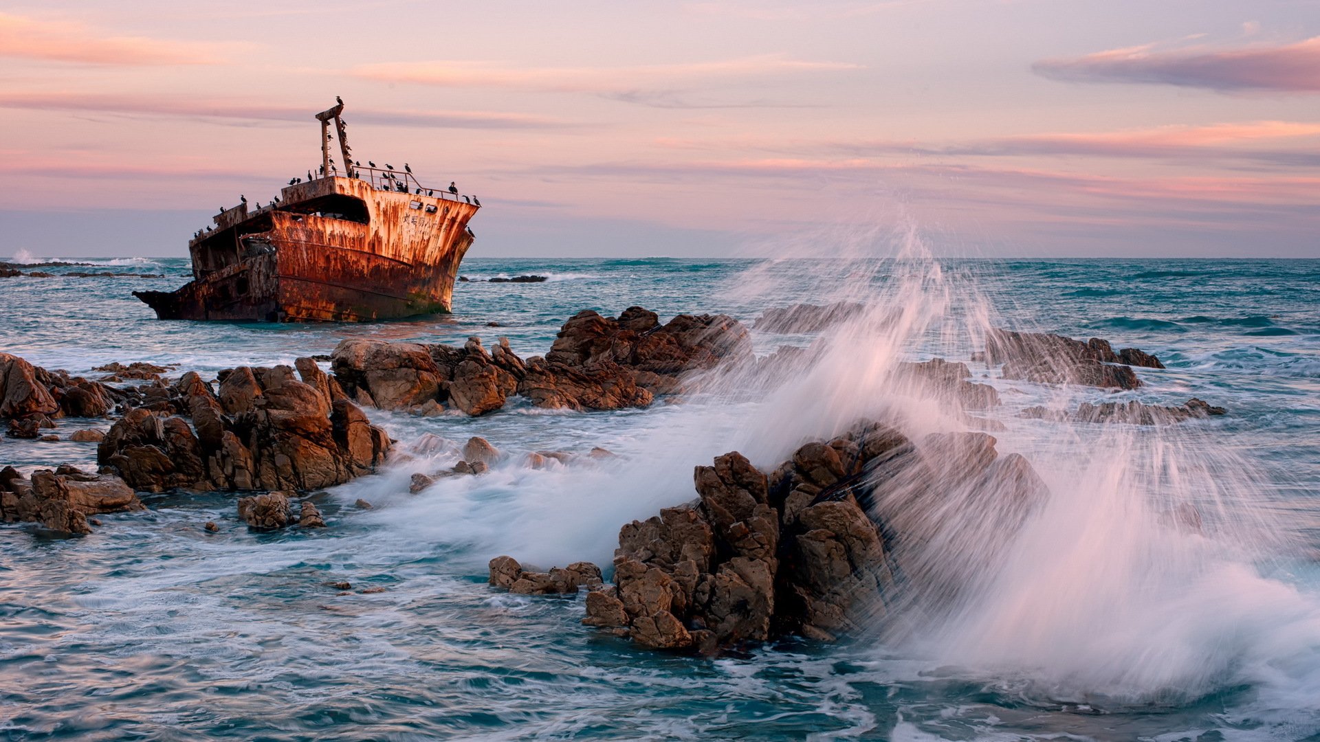 mare rocce nave onde tramonto paesaggio