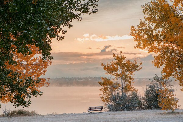 A bench in a snow-covered park