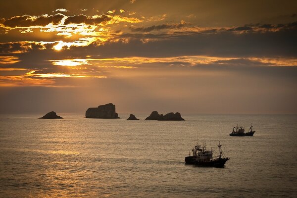 Ships at sea at sunset