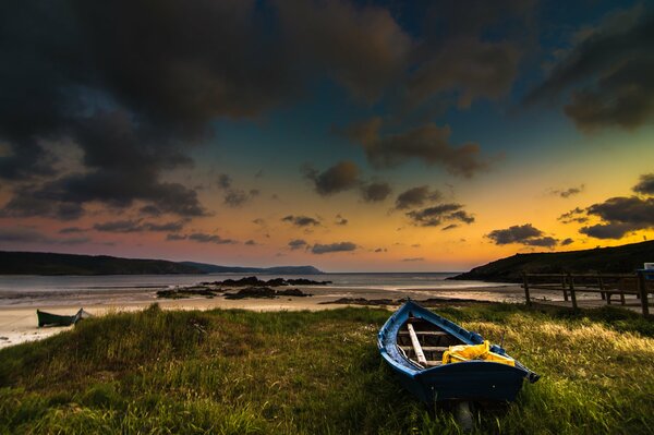 Boat on the shore of the dawn Bay