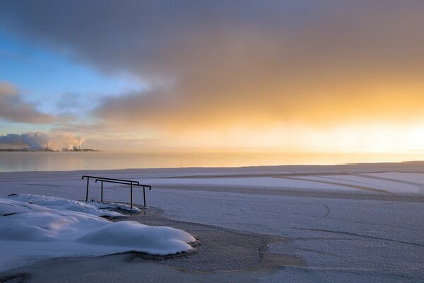 Winter sunset on the beach among beautiful clouds deserted shore