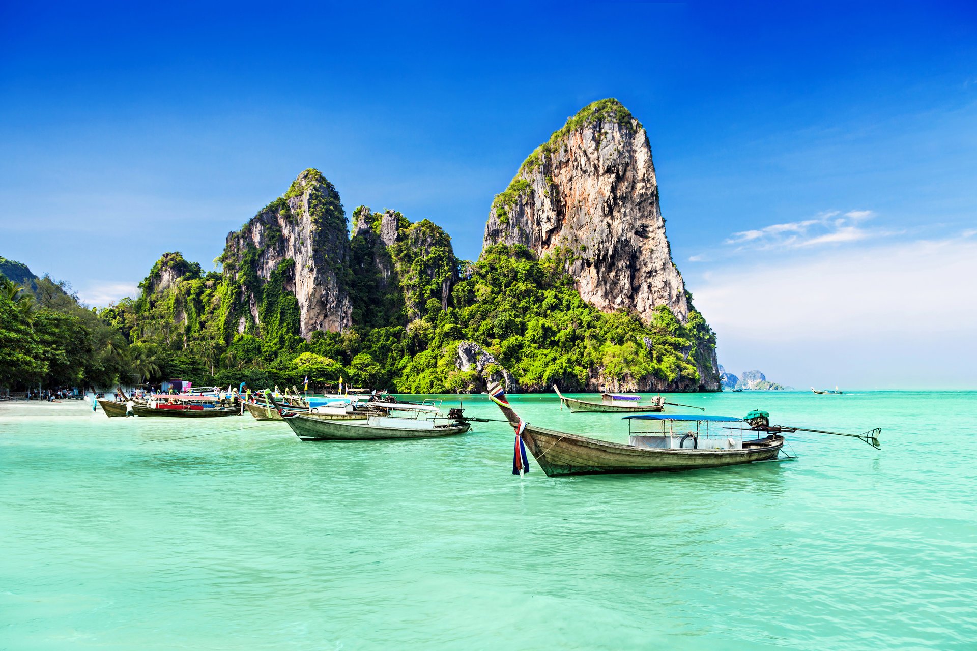 tropical paradise sea coast rocks trees boats rock