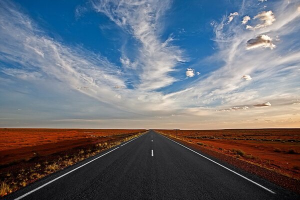 An endless straight road to the clouds